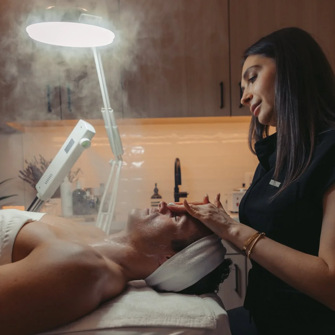 A man is receiving facial treatment at Ritual by Tracy Holzman NP-C in Washington, DC