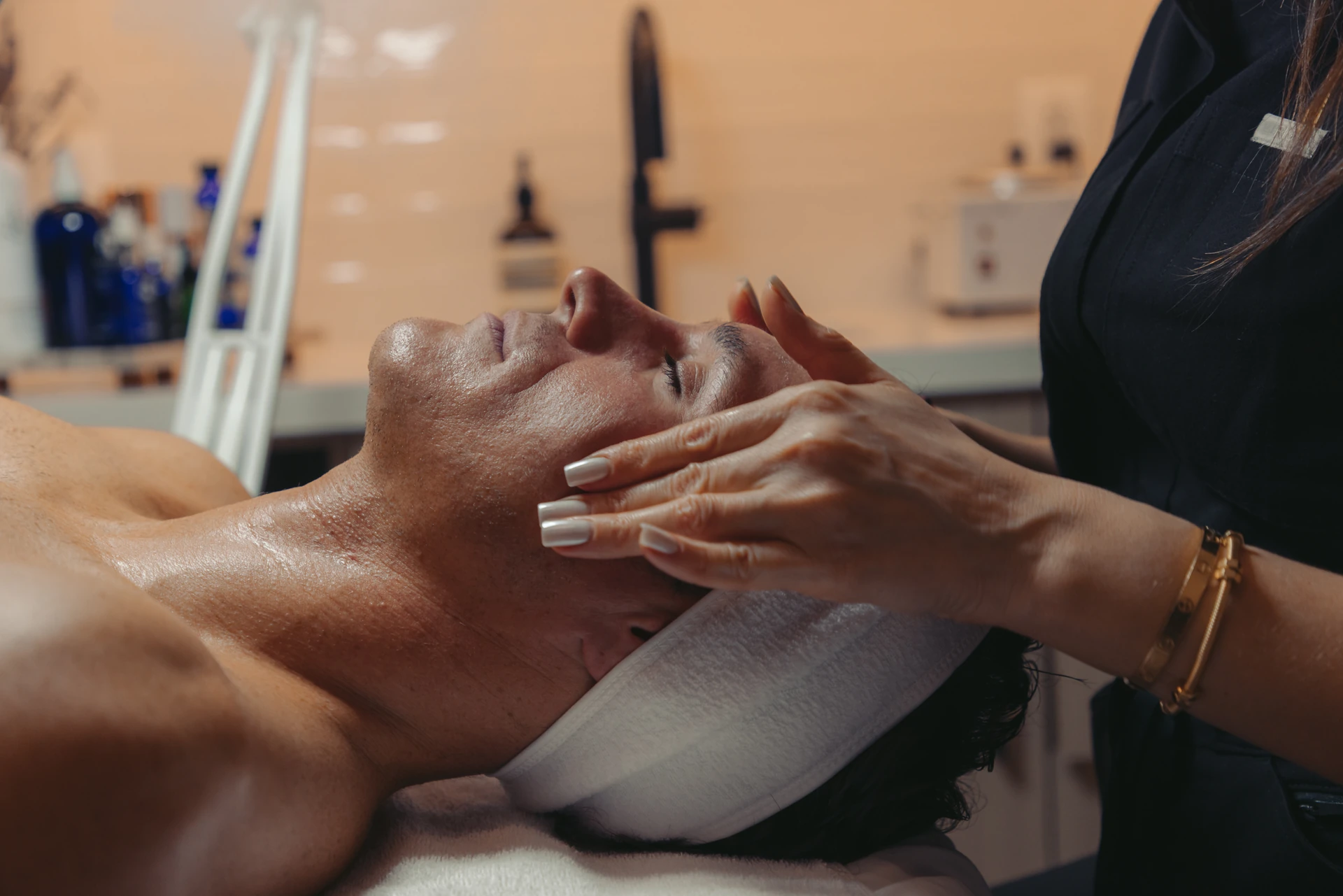 A woman is receiving skincare treatment at Ritual by Tracy Holzman NP-C