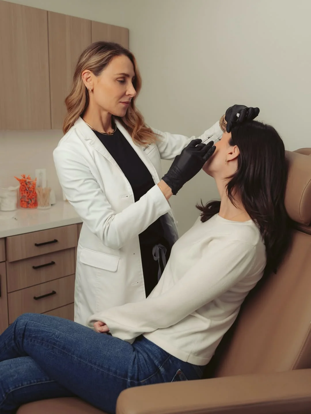 A woman is receiving medspa treatment at Ritual by Tracy Holzman NP-C in Washington, DC